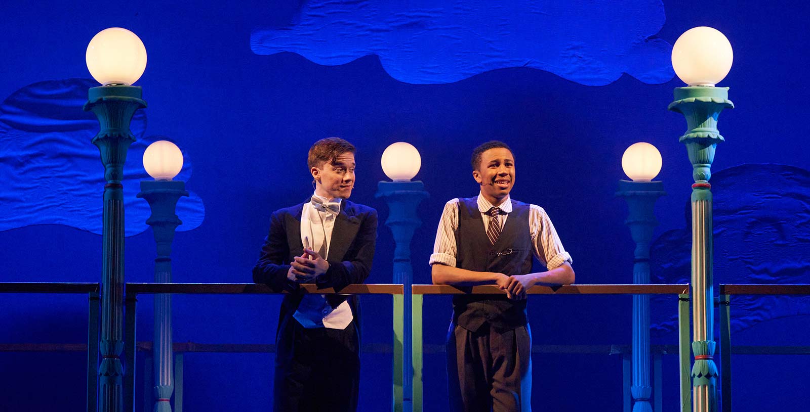 Production of the musical Kipps, two men standing on a boulevard lit by old style streetlamps